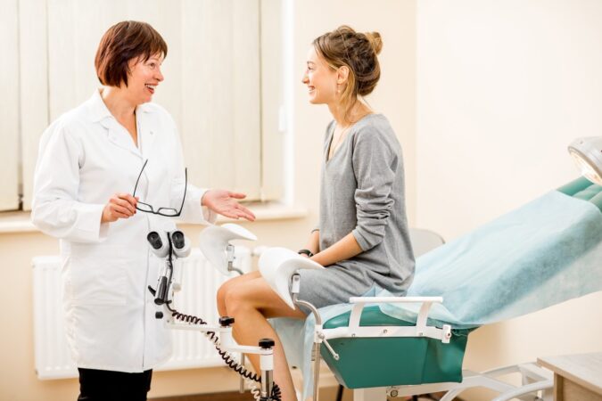 Young woman patient with gynecologist in the office first obgyn appointment