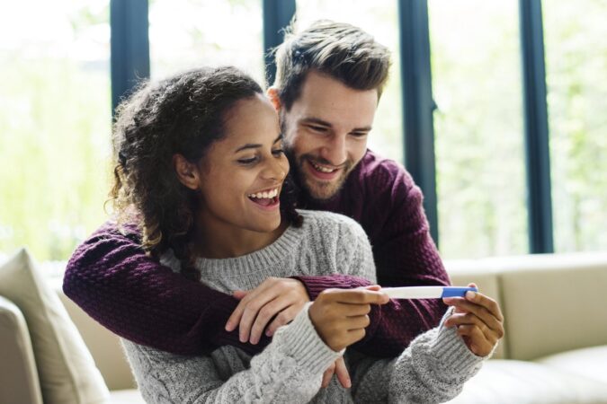 Happy couple with pregnancy news when can you find out gender of baby